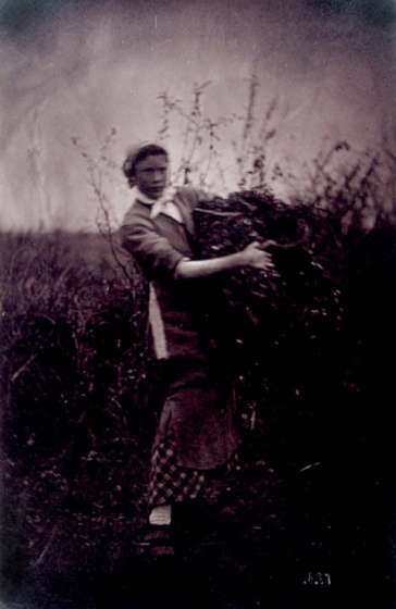 Woman Holding Burden in a Field