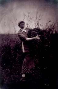 Woman Holding Burden in a Field