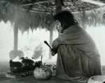 Praying in the god-house while copal incense burns in the pots